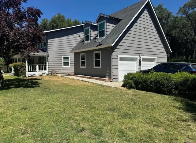 Two-story home with gray siding, white trim and an attached garage