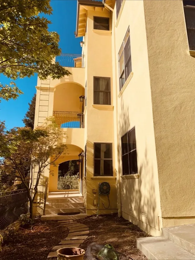Ochre stucco building with balconies and arched openings